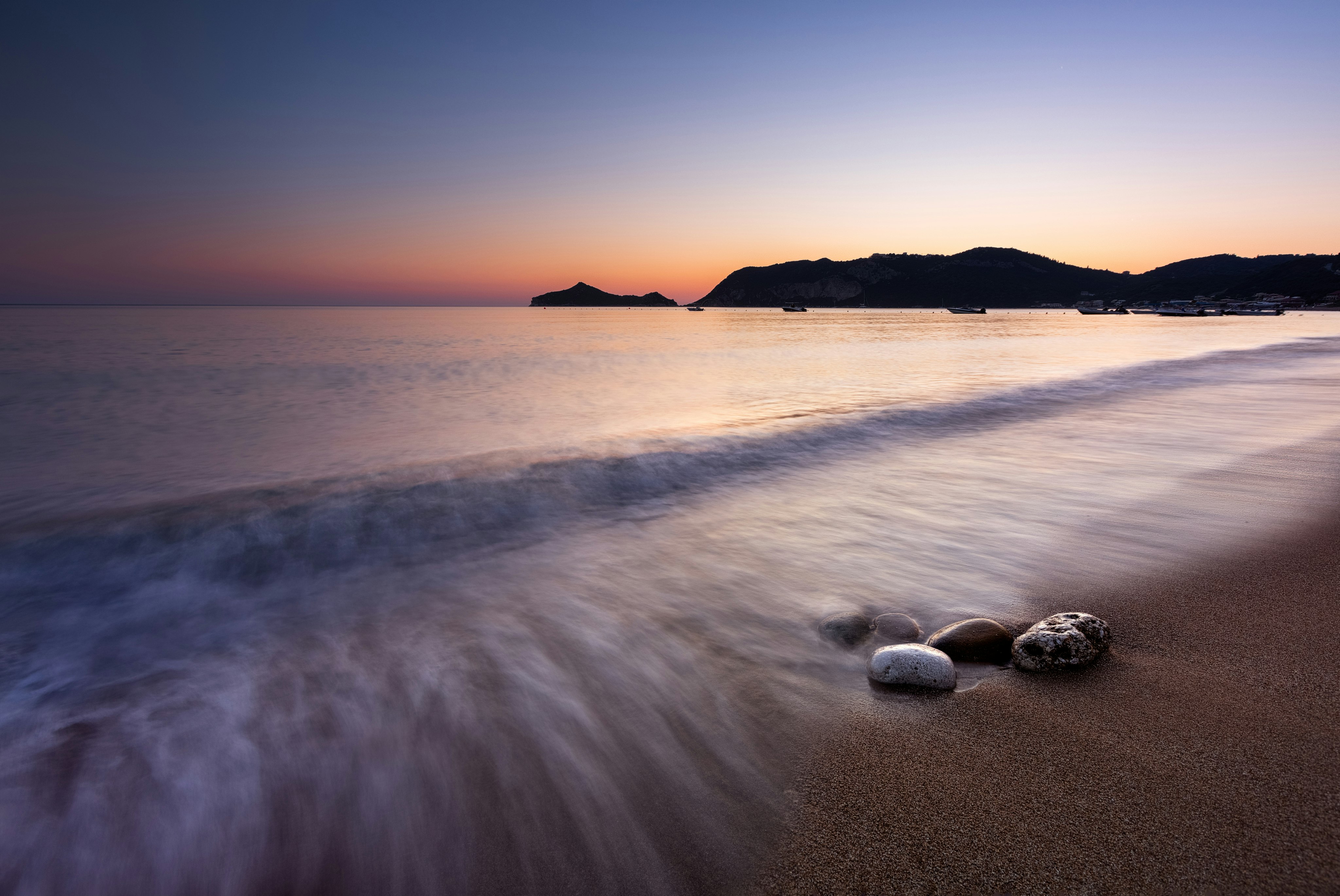 white stones on seashore during sunset